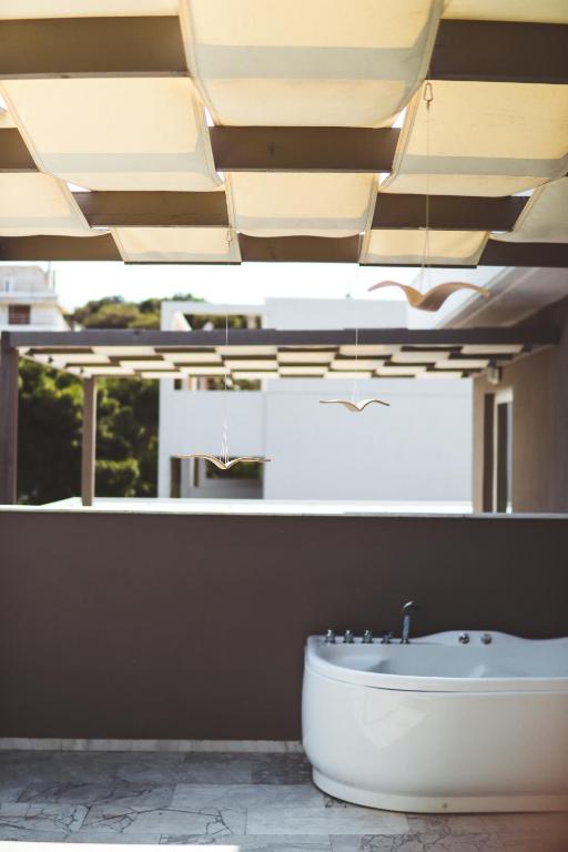 a bathroom with a bath tub and a sink at Athenian Riviera Hotel& Suites in Athens