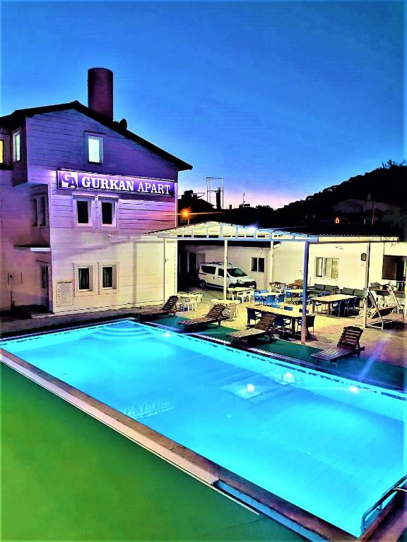 a large swimming pool in front of a building at Gurkan Apart Hotel in Dalyan