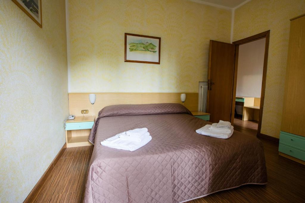 Postel nebo postele na pokoji v ubytování Hotel La Tavernetta dei Ronchi
