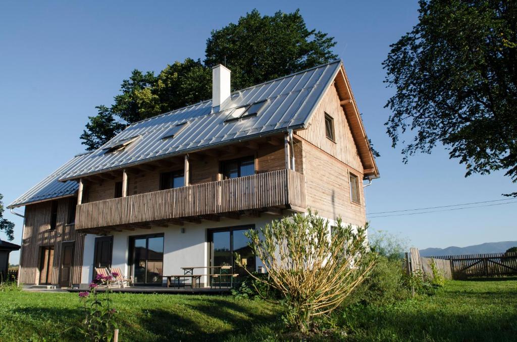 a house with solar panels on the roof at Dom Pod Lipami in Blatnica