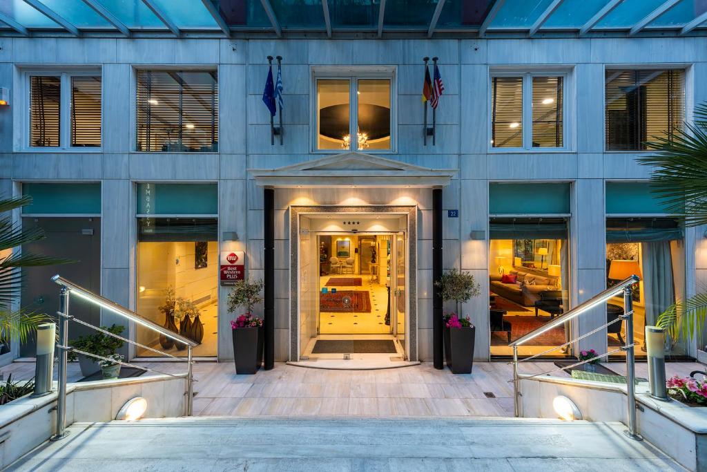 a facade of a building with a revolving door at Best Western Plus Embassy Hotel in Athens