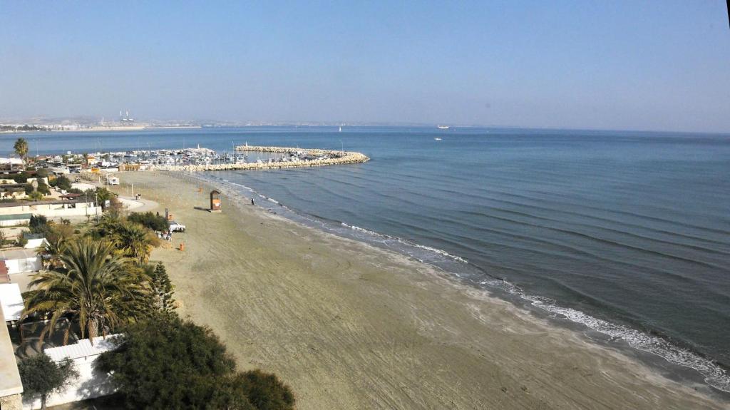 a view of a beach with a pier and the ocean at Stadem Studios in Larnaca