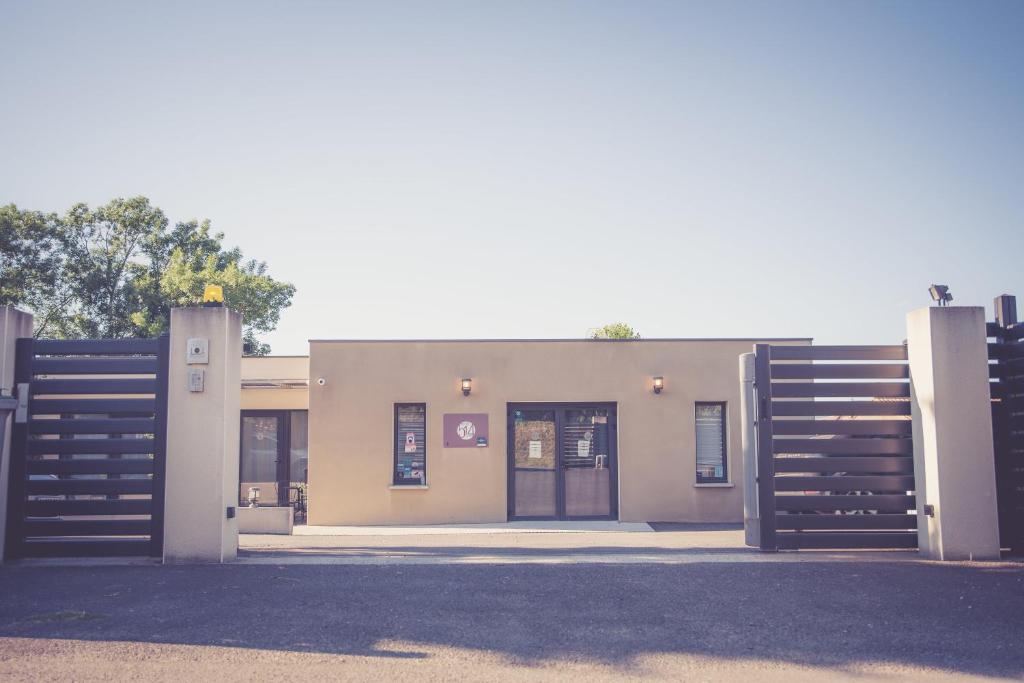 a building with two gates in front of it at 514 Appart Hotel in Carcassonne