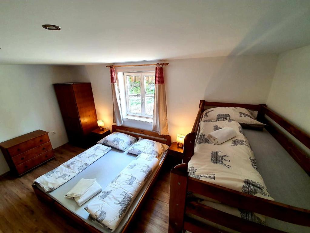 two twin beds in a room with a window at Penzión na Hálni in Nižná Boca