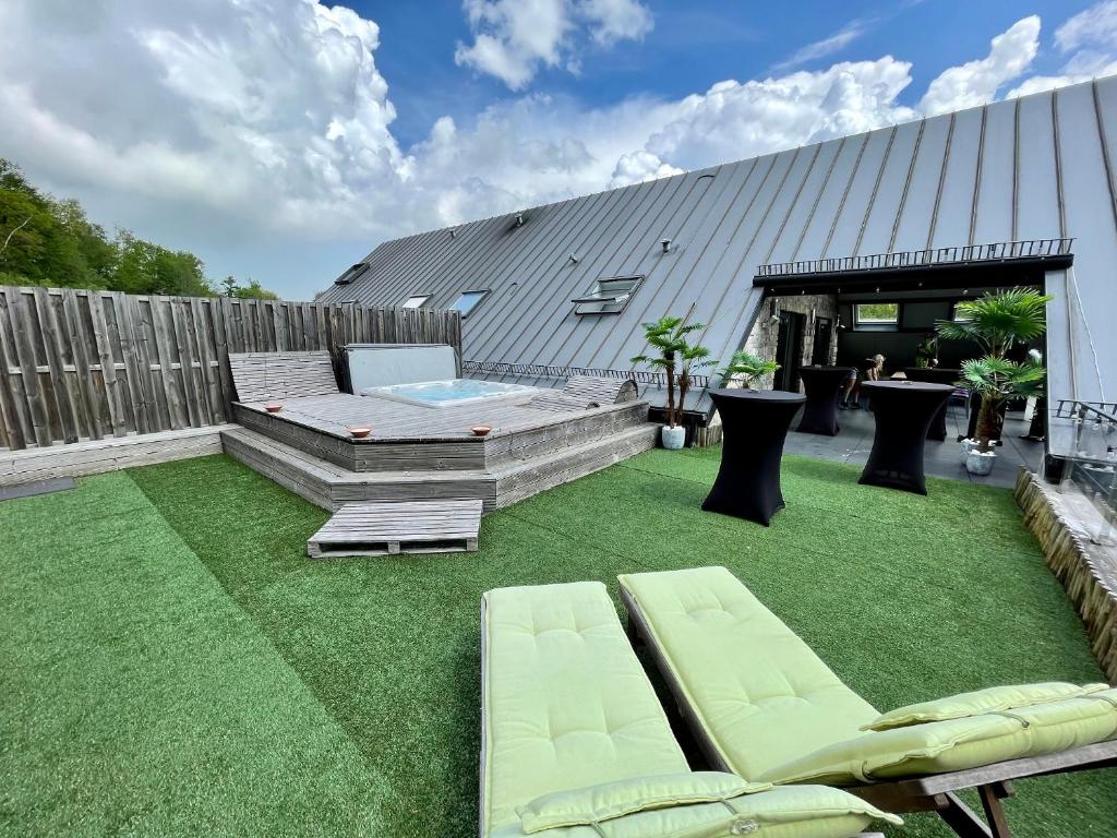 une cour avec de l'herbe verte et une piscine dans l'établissement Loft de prestige au pied du circuit, à Francorchamps