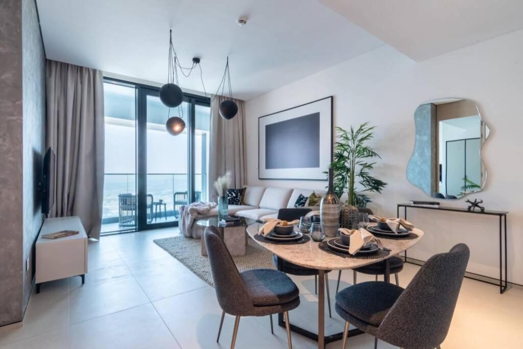 a living room with a table and chairs at The Smart Concierge - Address JBR in Dubai