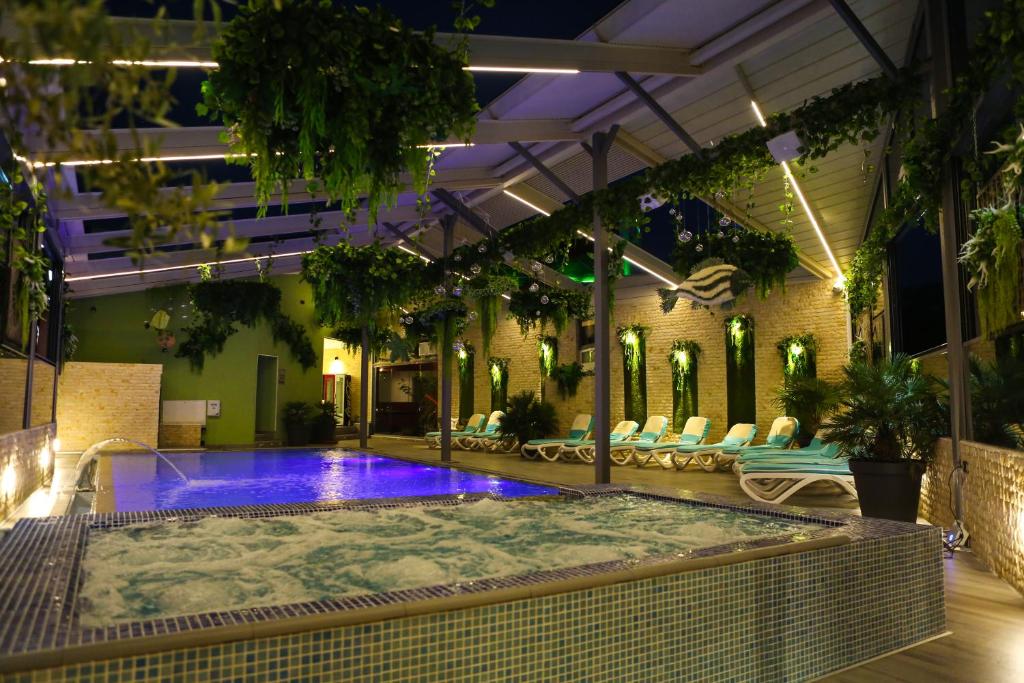 a swimming pool in a building at night at Hotel Regal in Costinesti