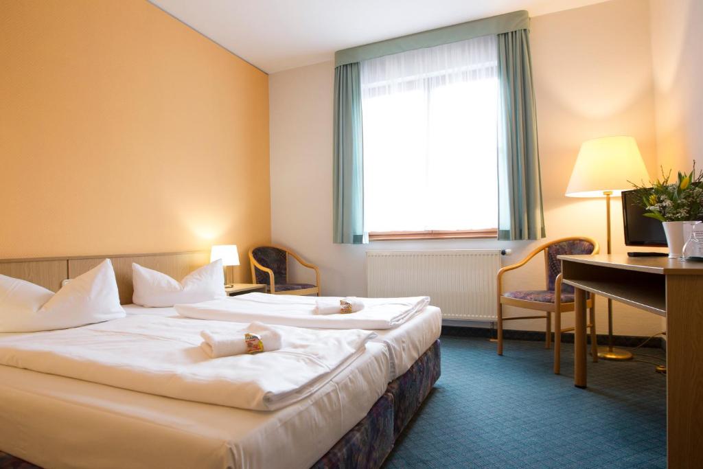 Voodi või voodid majutusasutuse Jembo Park Hotel toas