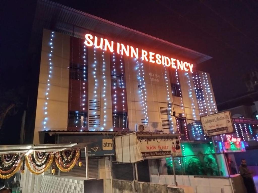 a sun inn residency is lit up at night at Sun Inn Residency in Mumbai