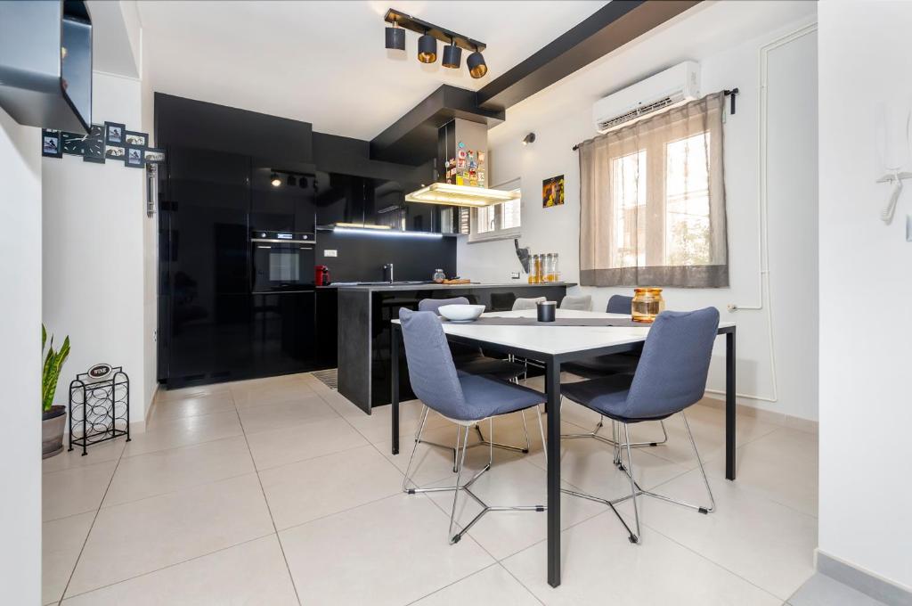 a kitchen with a table and chairs in a room at Apartment Cave in Rovinj