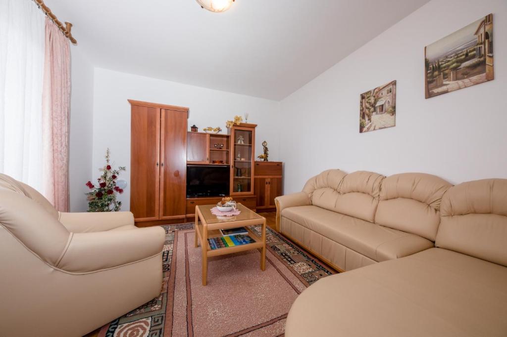 a living room with two couches and a table at Apartment in Mundanije with Seaview, Terrace, Air condition, WIFI (3748-1) in Mundanije