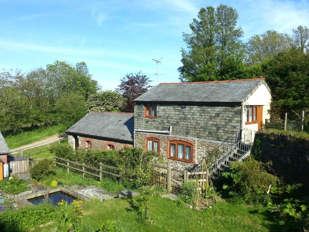 an aerial view of a house with a pond at Sunflowers Barn in Looe