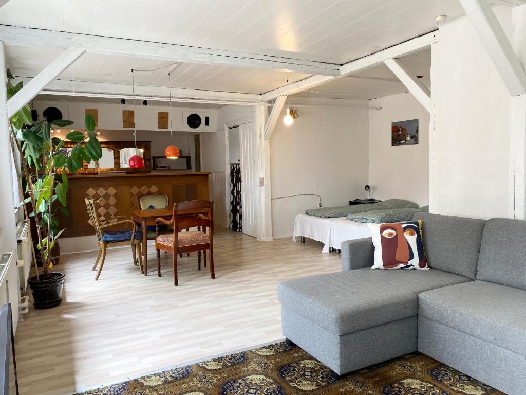 a living room with a couch and a bed at Studio Apartment in the heart of Højer in Højer