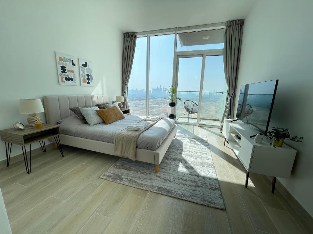 a bedroom with a bed and a large window at Brand New Top Skyline View Apartment in Dubai