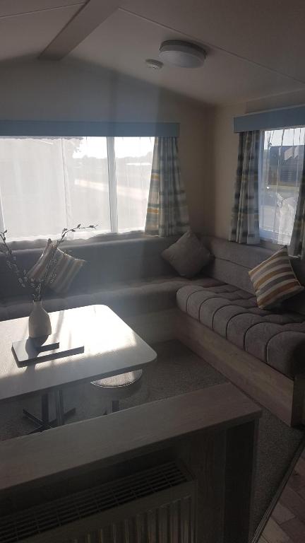 a living room with a couch and a table at KINGDOM HOLIDAY PARK - Parrot in Millom