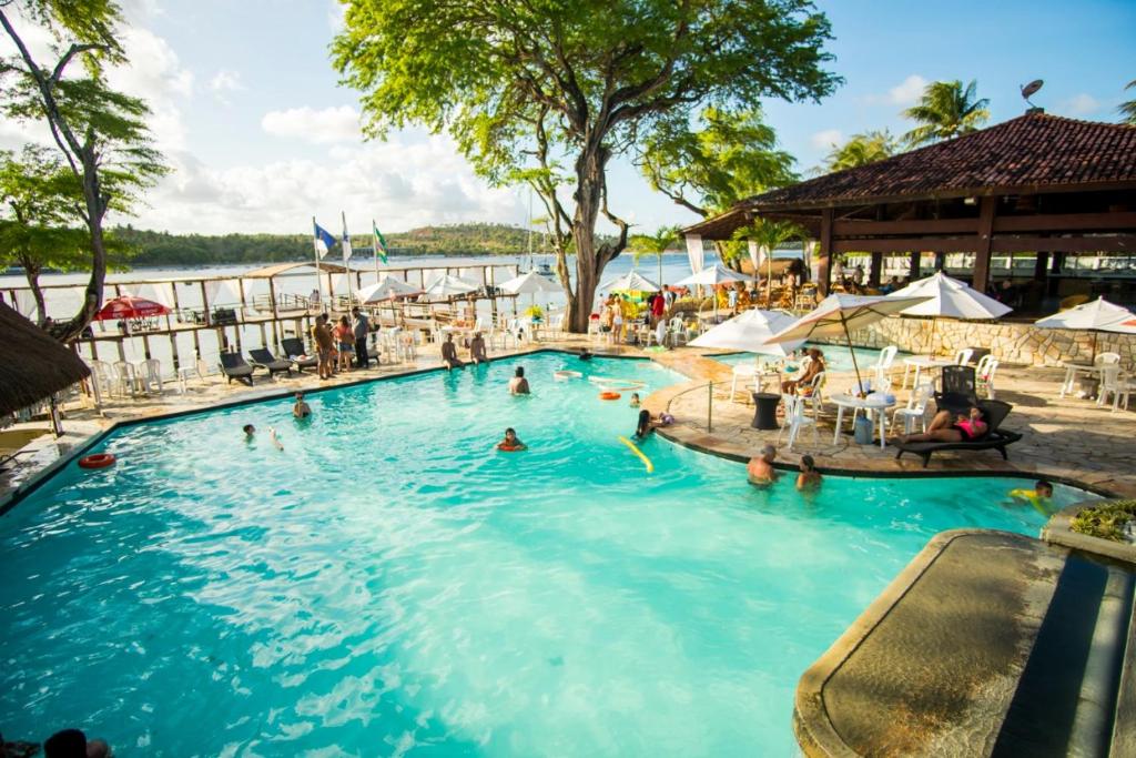 a large swimming pool with people in the water at Amoaras Resort in Maria Farinha