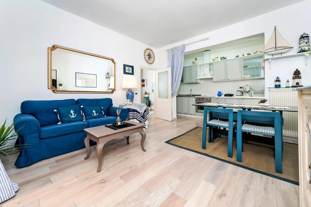 a living room with a blue couch and a table at Apartment Bassano in Rovinj