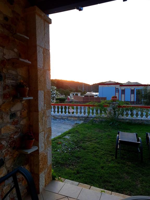a patio with a table and a chair next to a river at Edem Studios in Syvota