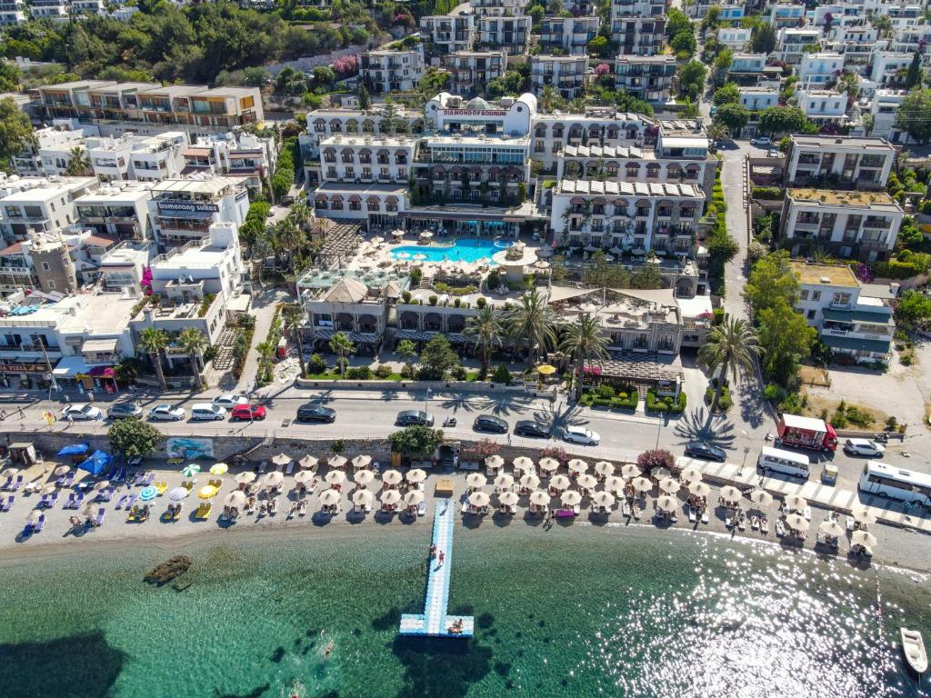 an aerial view of a beach with umbrellas and a resort at DIAMOND OF BODRUM in Bodrum City