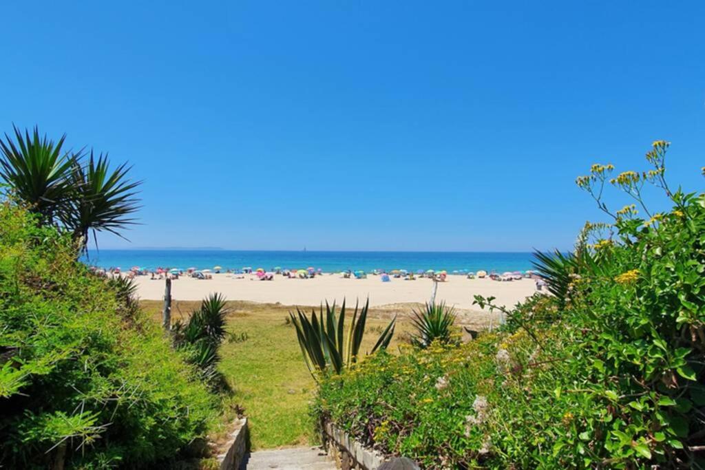 a beach with a bunch of people on the beach at Bolonia Beach Campus in Tarifa
