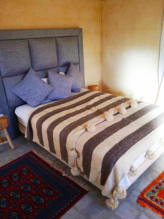 Postel nebo postele na pokoji v ubytování Le petit Jardin