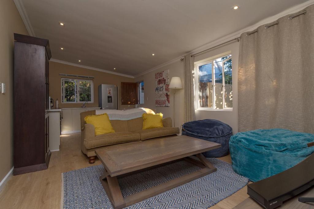 a living room with a couch and a table at The Garden on Phantom - "Off the grid" in Knysna