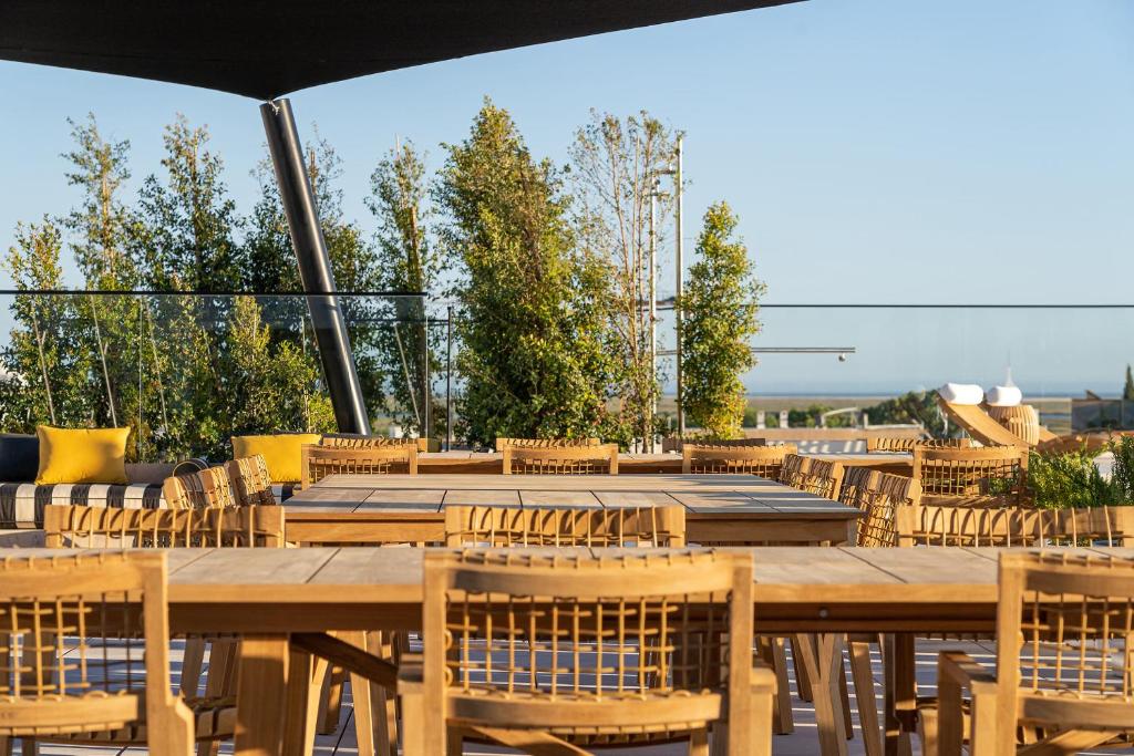 a large wooden table and chairs on a patio at 3HB Faro in Faro