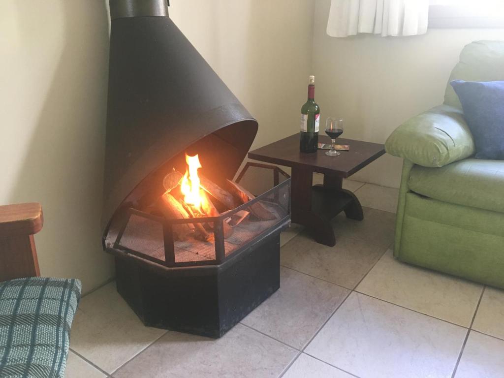 a living room with a fire in a fireplace at POUSADA TAQUARAS in Cassino