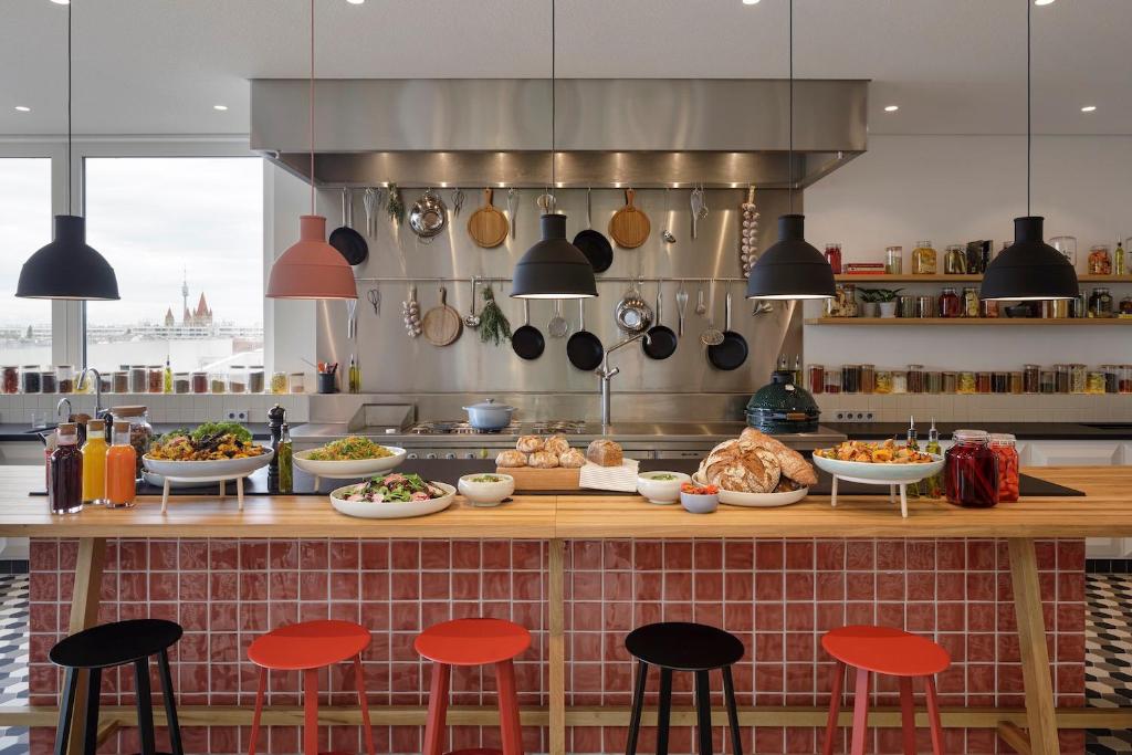 a kitchen with a counter with food on it at Zoku Vienna in Vienna