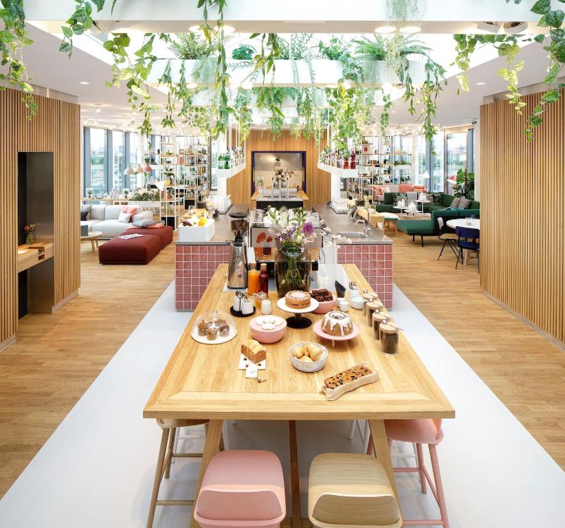 a dining room with a table and chairs at Zoku Vienna in Vienna