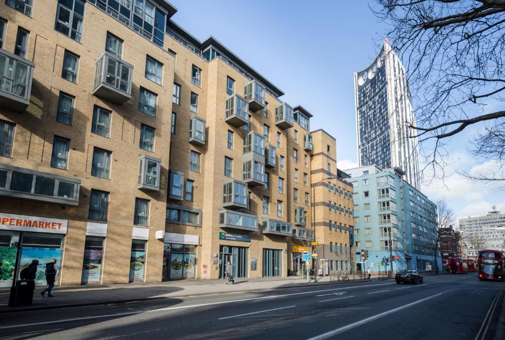 an empty street in a city with a tall building at Stunning Apartments at Dashwood Studios in London in London