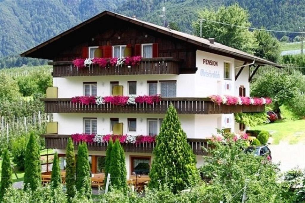 a large building with flowers on the balconies at Gletscherblick in Naturno