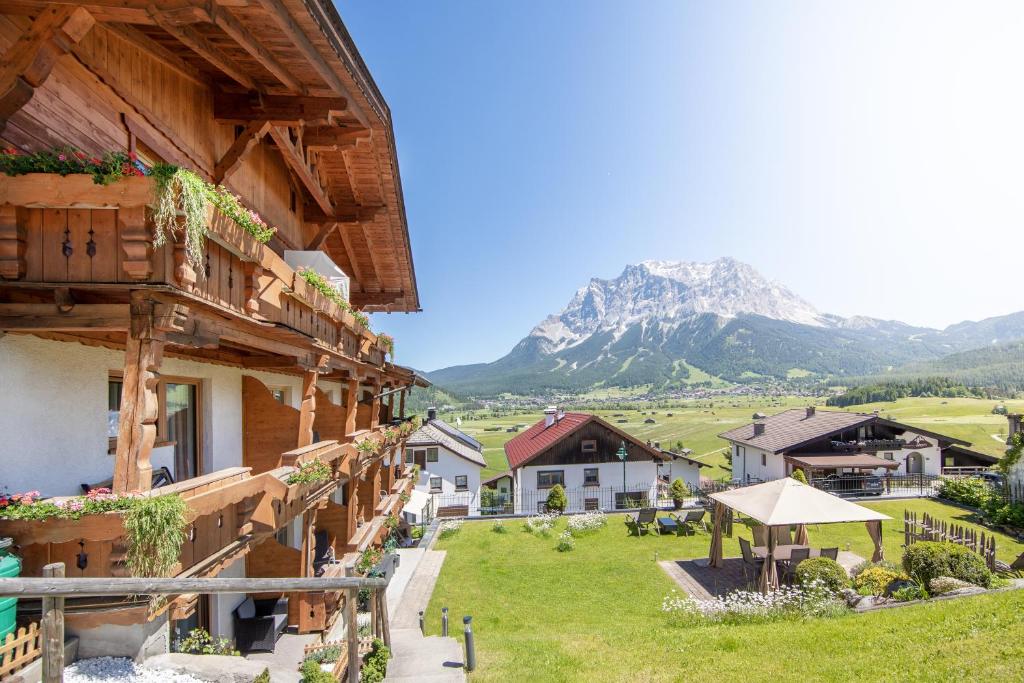a view of a house with a mountain in the background at Apart Haus Alpenhof in Lermoos