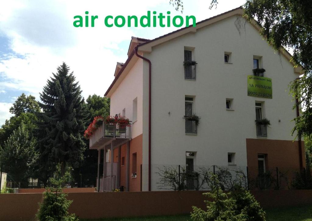 a white building with a sign that reads air condition at Penzion Park - 2 izbové apartmány in Nové Mesto nad Váhom