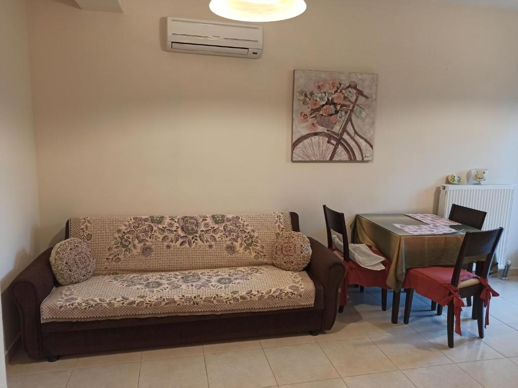 a living room with a couch and a table at Elisso Apartment in Argostoli