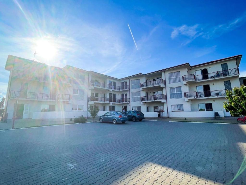 a building with a car parked in a parking lot at Amphora Vibes in Vama Veche