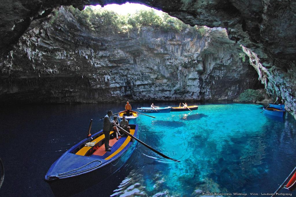 a group of people in boats in a cave at Elisso Apartment in Argostoli