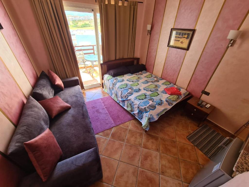 a living room with a couch and a bed at Studio avec piscine à Mirador cabo négro in Cabo Negro