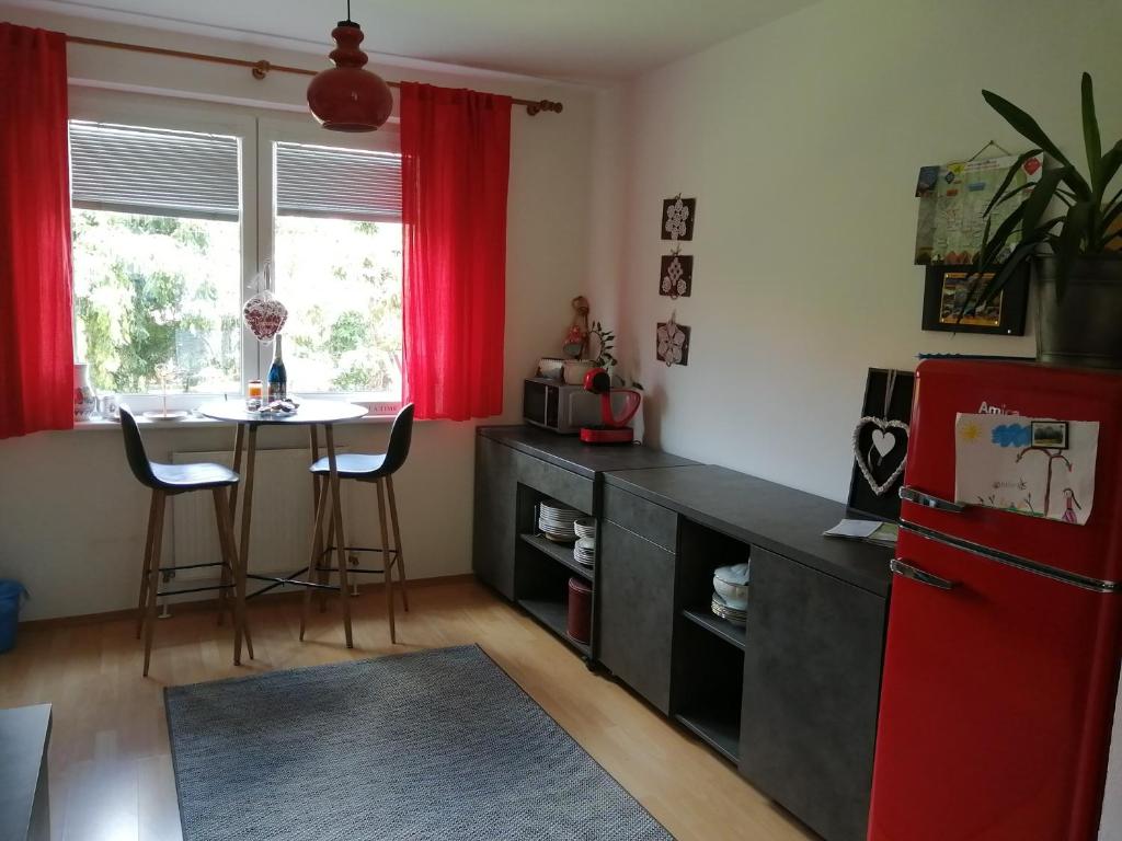 a kitchen with a table and a red refrigerator at EMMA in Nová Lesná