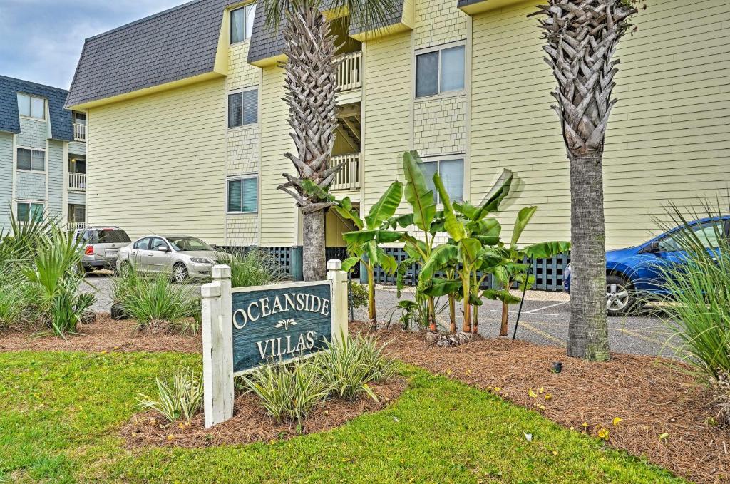 a sign in a yard in front of a building at Coastal Condo with Pool Access - Walk To Beach! in Isle of Palms