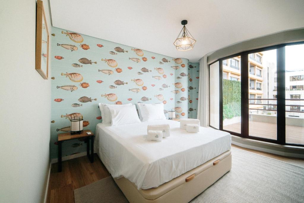a bedroom with a bed and a wall with fishes at Rooftop Marina ll by Madeira Best Apartments in Funchal