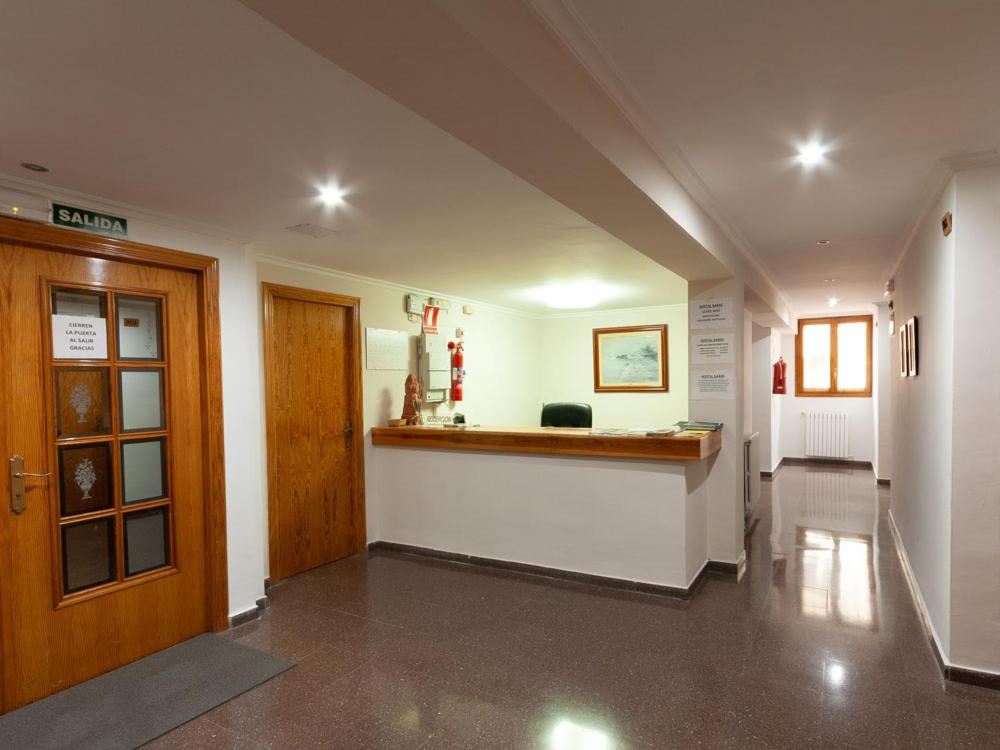 a hallway of a building with a bar in it at Hostal Gabás in Borja