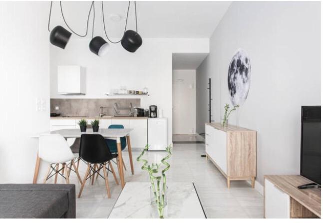 a kitchen and dining room with a table and chairs at Dion Suites in Athens