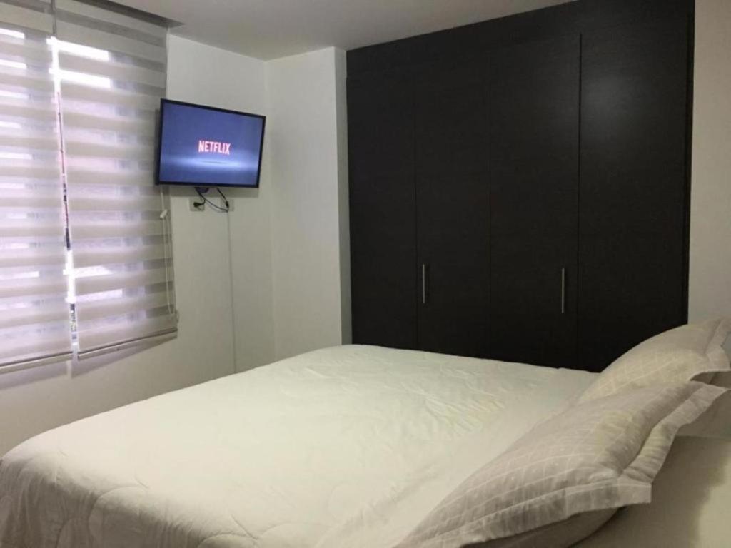 Postel nebo postele na pokoji v ubytování Misuitehotel La Carolina Quito
