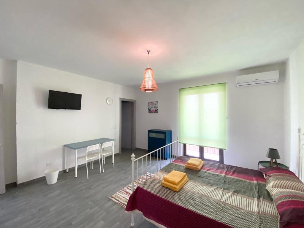 a bedroom with a bed and a table and a tv at 35 Passi dal mare B&B in Cirò Marina