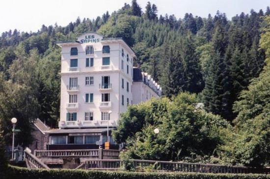 a large white building on the side of a mountain at Studio 2 personnes in Le Mont-Dore
