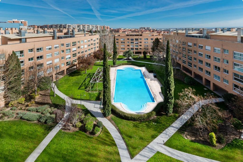 an overhead view of an apartment complex with a swimming pool at Los Castaños Design Apartments in Conde Orgaz in Madrid