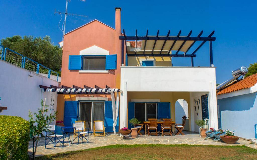 a house with a patio in front of it at Blue Paradise maisonette in Paliouri