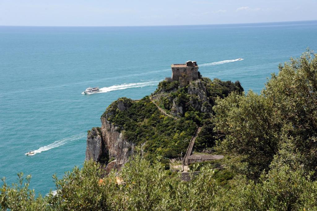 a castle on top of a mountain in the ocean at Hotel Belvedere in Conca dei Marini