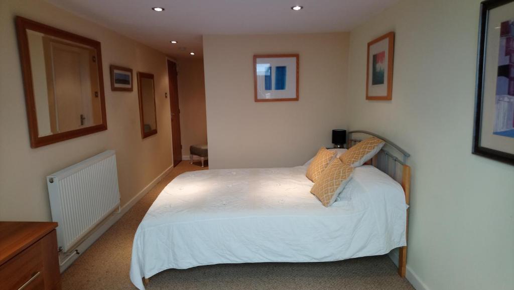 a bedroom with a white bed in a room at The Room With The View in Overstrand